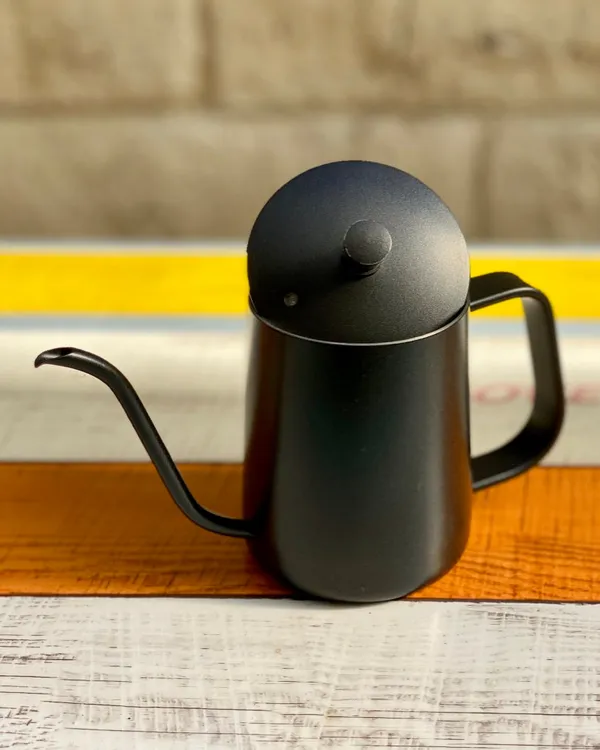 Matte black gooseneck pour-over kettle on a wooden counter